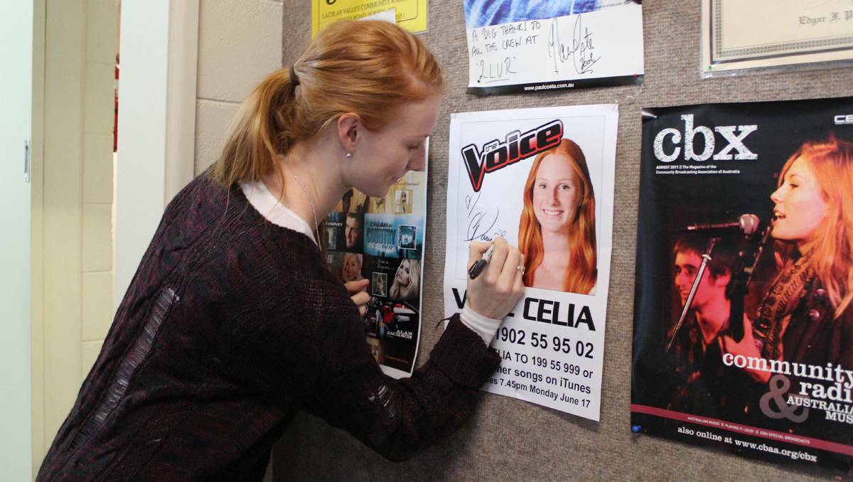 FORBES: Singer Celia Pavey signs a poster at the Valley FM studio.