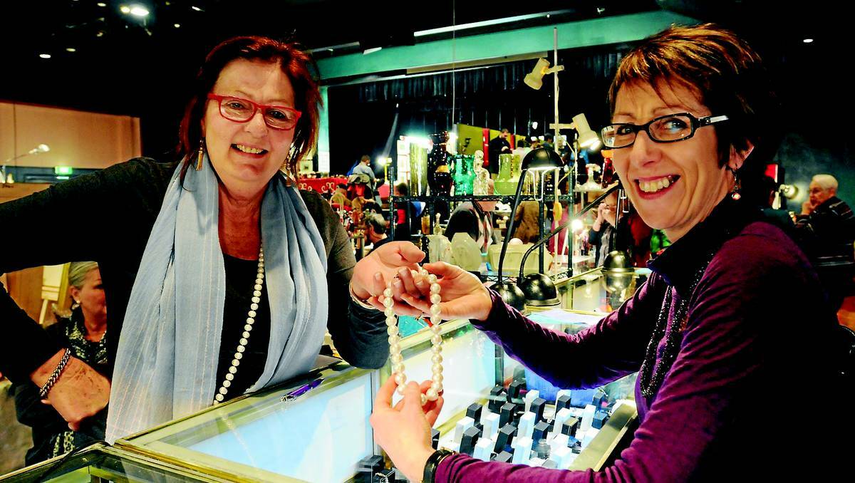 ORANGE: Margot Lees, who had a stall at the the first Zonta antique fair 30 years ago and hasn’t missed one since, shows president elect of Zonta Frances Young a string of pearls on Sunday.