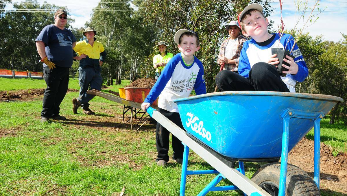 DUBBO: Adrian Armstorng, Mark Raimes, Tim Shipard, Connor Armstorng, Phil Carney and Oliver Armstorong having fun planting trees to mark National Tree Day. Photo: JOSH HEARD