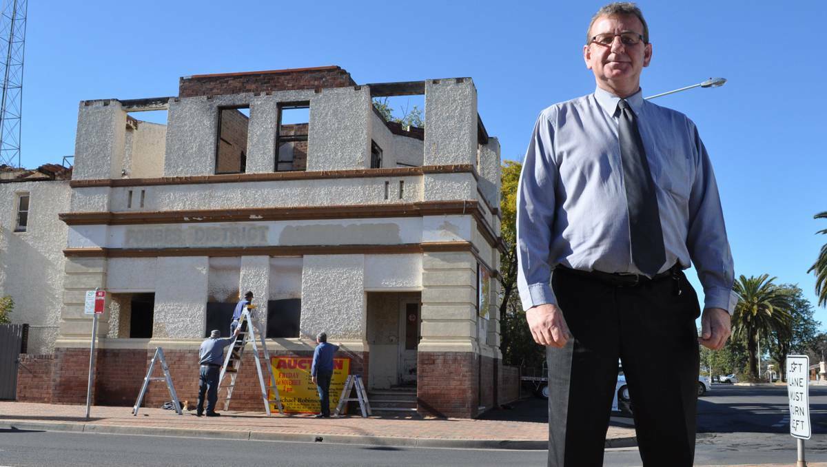 FORBES: The ruins of Forbes’ ambulance station on Lachlan Street could be sold if the owner can not produce overdue rates of more than $50,000. Pictured: Forbes Shire Council's general manager Brian Steffen outside the former ambulance station.
