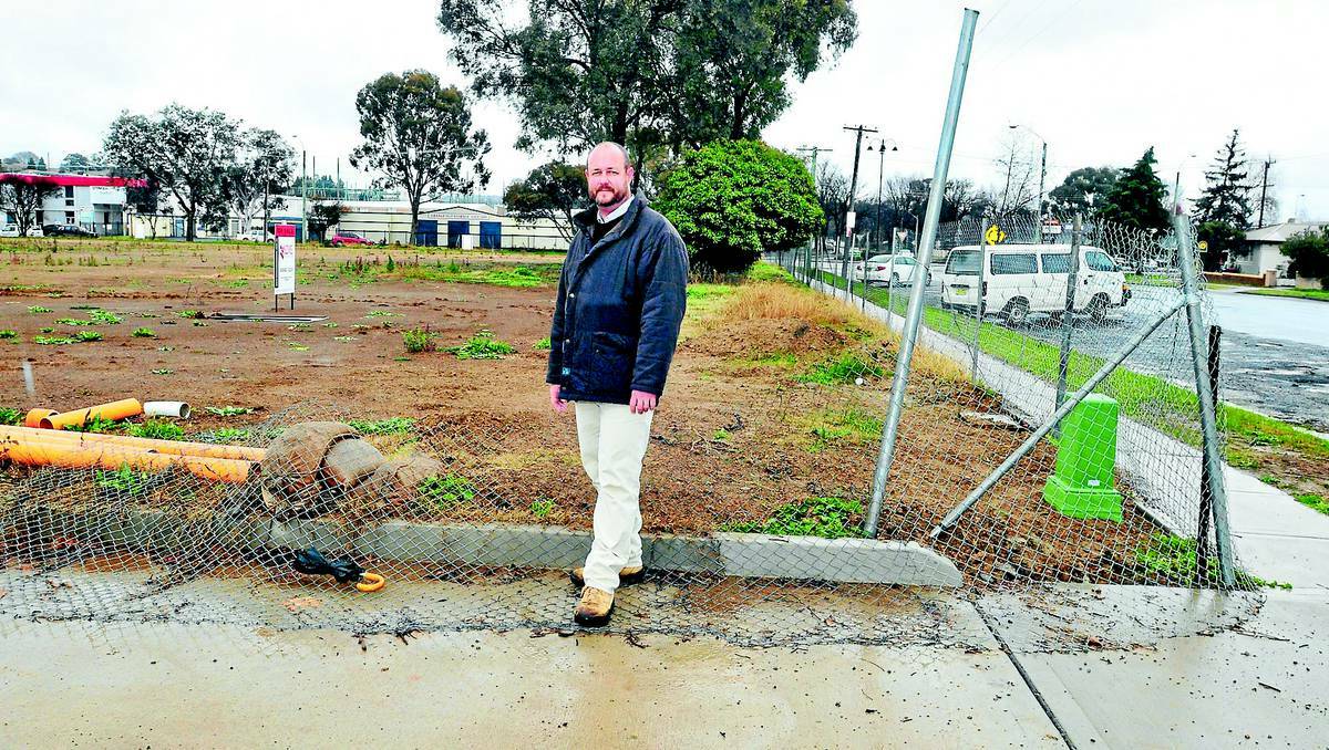ORANGE: Designer Ben O’Halloran at the site of the new childcare centre earmarked for the corner of McLachlan and Dalton streets. Photo: JUDE KEOGH 0715childcare1