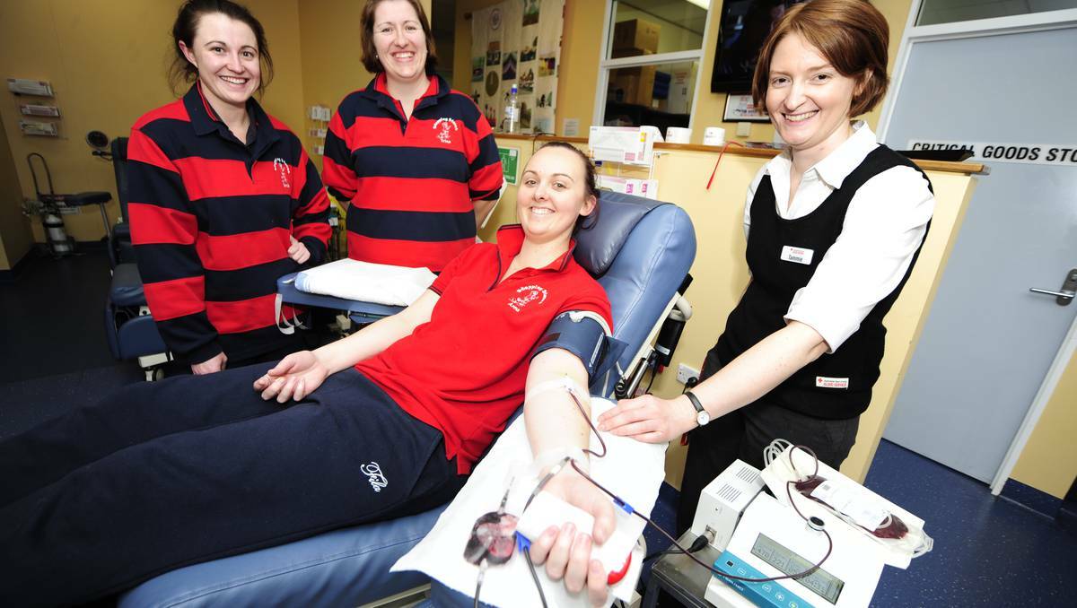 DUBBO: TO mark National Childcare Week, Stepping Stones Childcare centre led its team to the city’s blood bank. Pictured here are Sarah Blanch, Katrina Janhsen and Anna Semmler giving blood as Tammie Cornford encourages them. Photo: BELINDA SOOLE