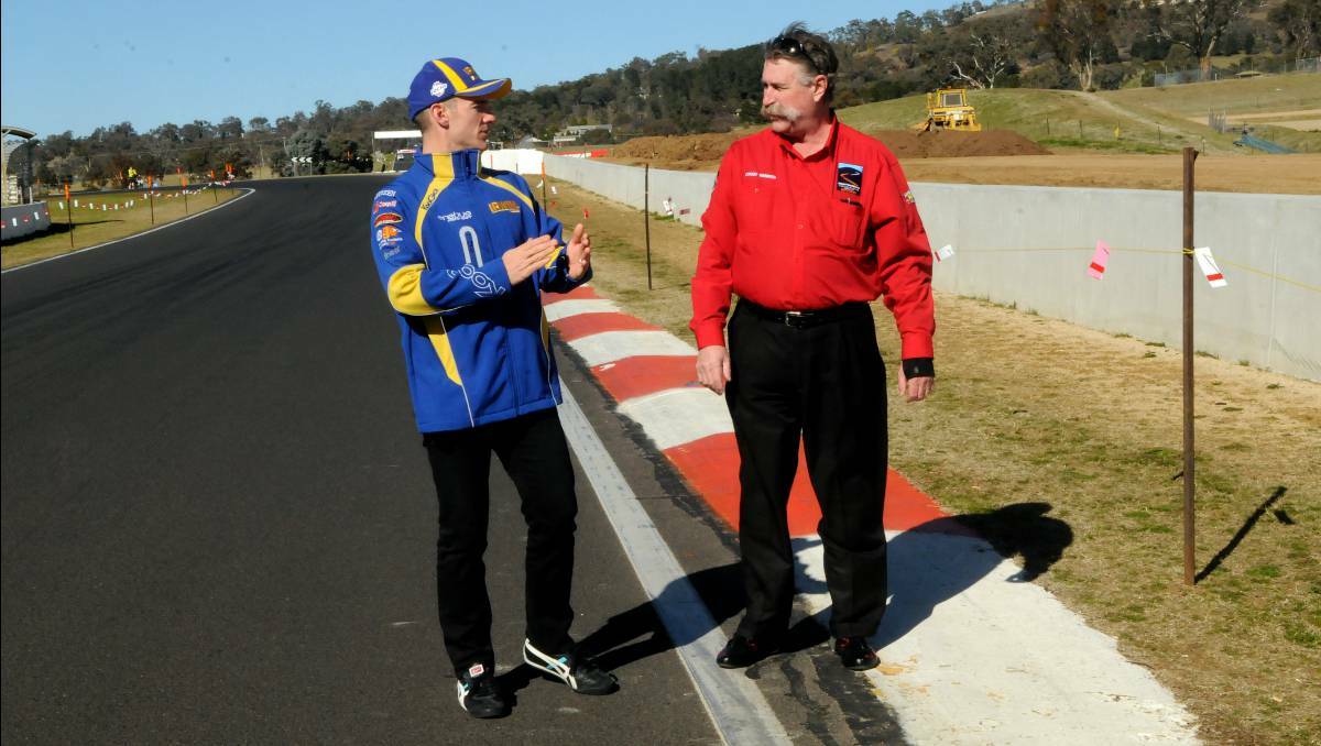  V8 Supercar driver Lee Holdsworth and Mount Panorama circuit manager Mark Rayner inspect the changes to The Chase which are aimed at making the track safer. Photo Phill Murray, 2013.