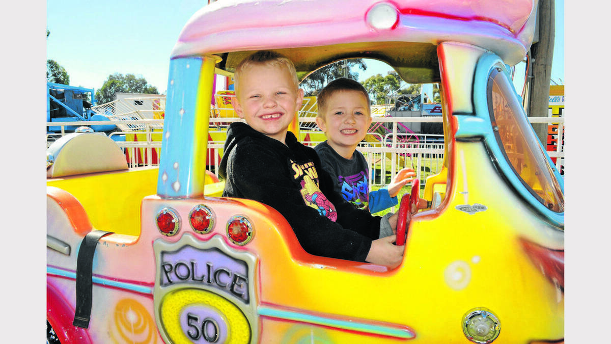 PARKES: Bryce Reynolds (5) and Bayley Callaghan (6) had a blast driving this fun police car at the Parkes show.