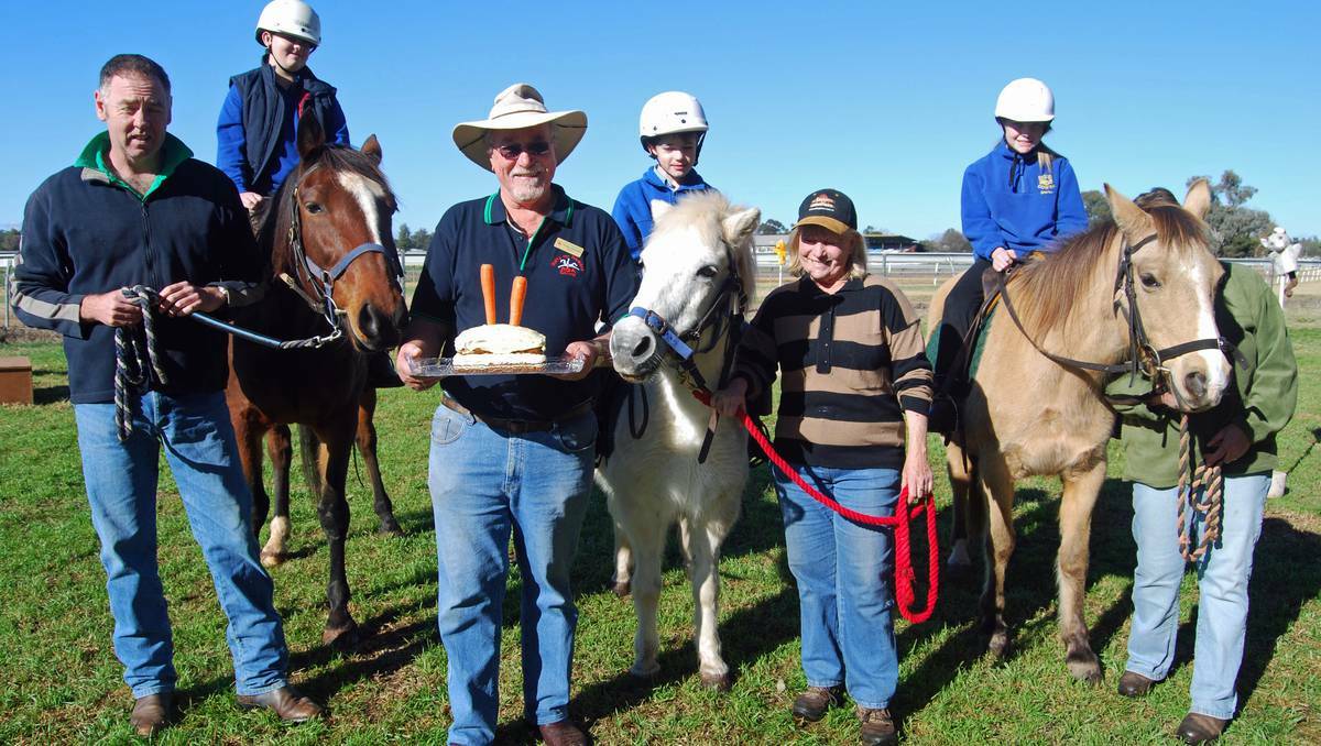 COWRA: Cowra Public School students Connor Charnock, Aedan Leatherland and Sharlee Williams, along with volunteers Tom McSorley, President Dudley Nicholson, Raelene Searle and Michele Smith help horses Jack, Crystal and Goldie celebrate their birthday with a double layer carrot cake.