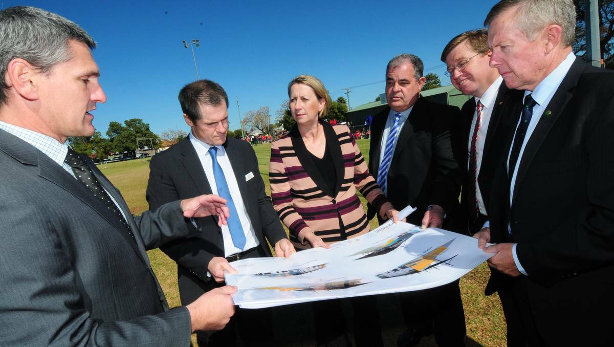 DUBBO: Murray Wood from Dubbo City Council, Dubbo mayor Mathew Dickerson, Minister for Regional Development Sharon Bird, Regional Development Australia - Orana chairman John Walkom, state Member for Dubbo Troy Grant and federal Member for Parkes Mark Coulton inspect the plans for the 500-seat grandstand and all-weather track. Photo: LOUISE DONGES