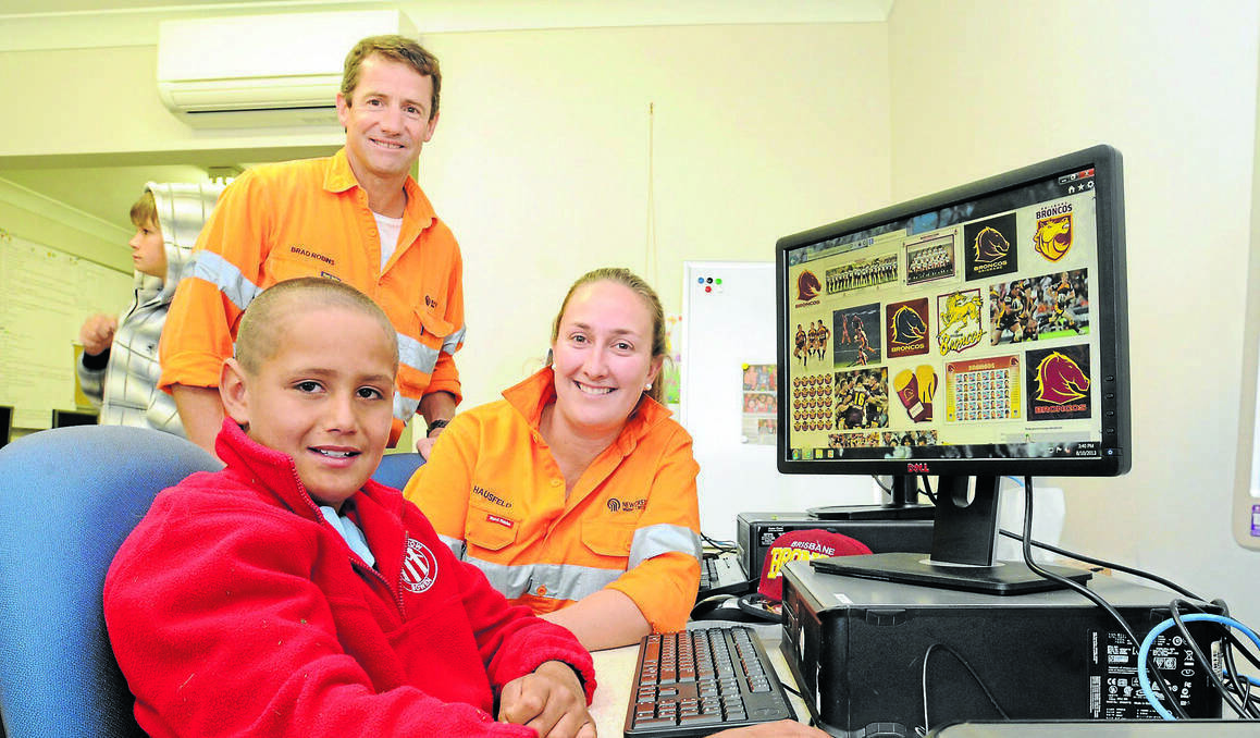 ORANGE: Brad Robins and Alex Cook from Cadia Valley Operations’ community partnerships committee with Michael Whitton at the Bowen Community Technology Centre. The mining company has donated $30,000 to ensure the centre remains open for the next 12 months. Photo: JUDE KEOGH