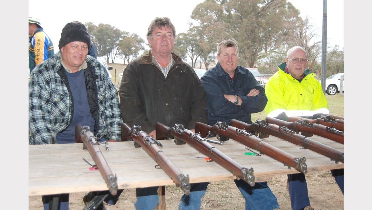 BLAYNEY: Shooters gathered together at the Lyndhurst Rifle Club on Saturday to celebrate 100 years of history. Shooting enthusiasts, Peter Bruem, Rod Bates, Andrew Baker and Reg Bennett seated with a display of 303 calibre rifles on the day. Photo: Wayne Cock.