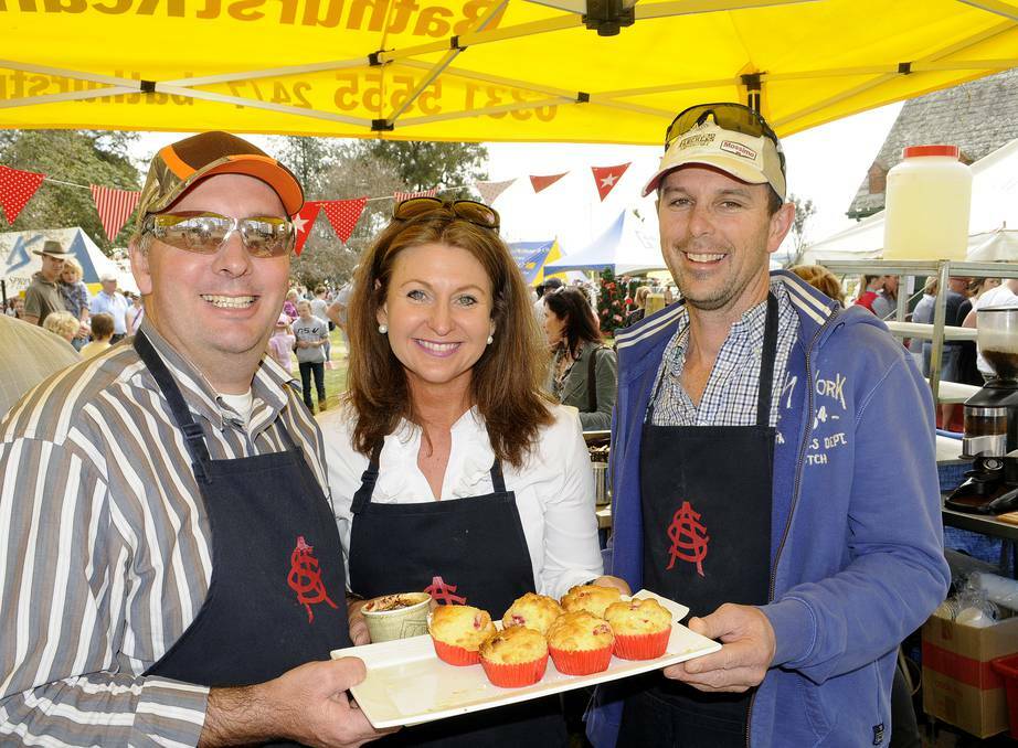 BATHURST: Serving up some tasty treats at the All Saint's College fair on Sunday were Paul Brabham with Louise and Michael Goddard. Photos: CHRIS SEABROOK 091513casc11a