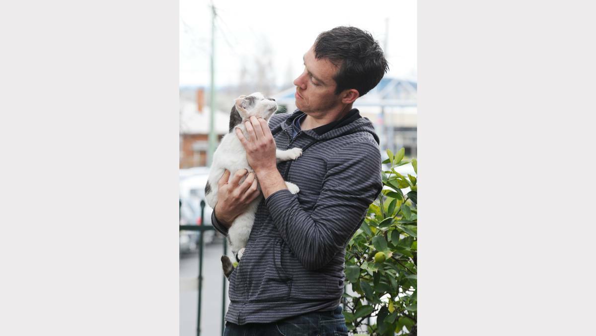BATHURST: Ben Fitzgerald with Ping Pong, the treasured cat from Pigments and Palettes, who turned up a little worse for wear on Thursday after going missing five days earlier. Photo: ZENIO LAPKA	 071813zpet2