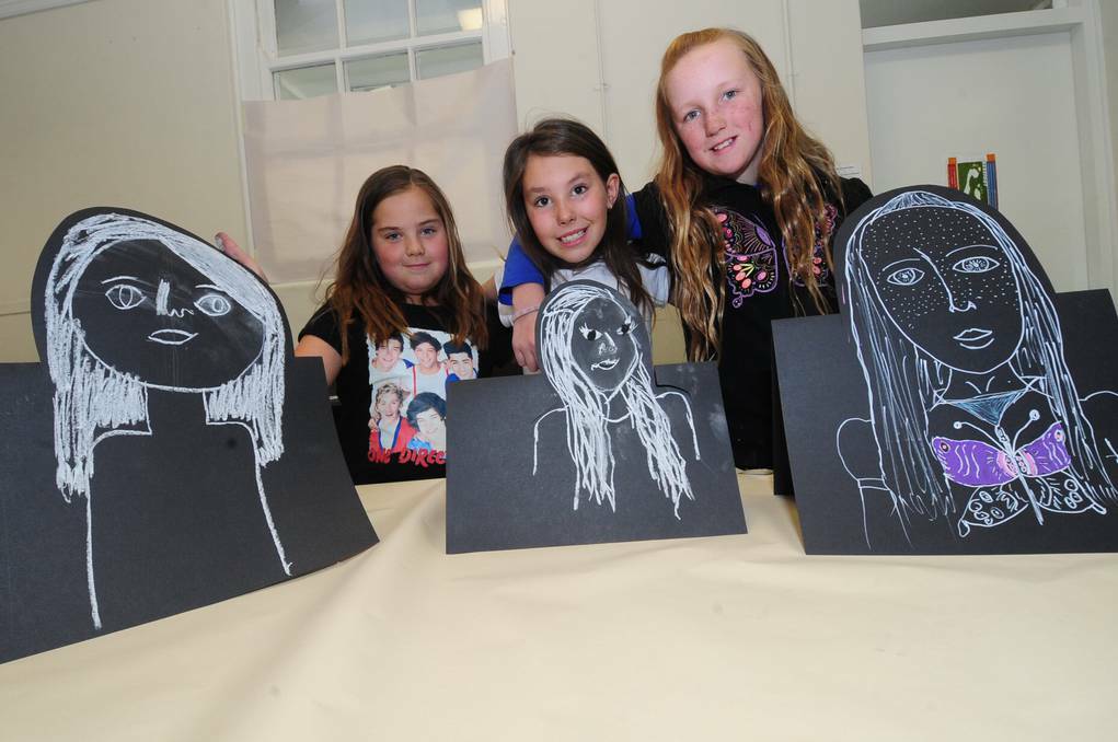 DUBBO: Ella Byrnes, Maddison Thompson and Holly Darlington with their self-portraits at the Western Plains Cultural Centre.