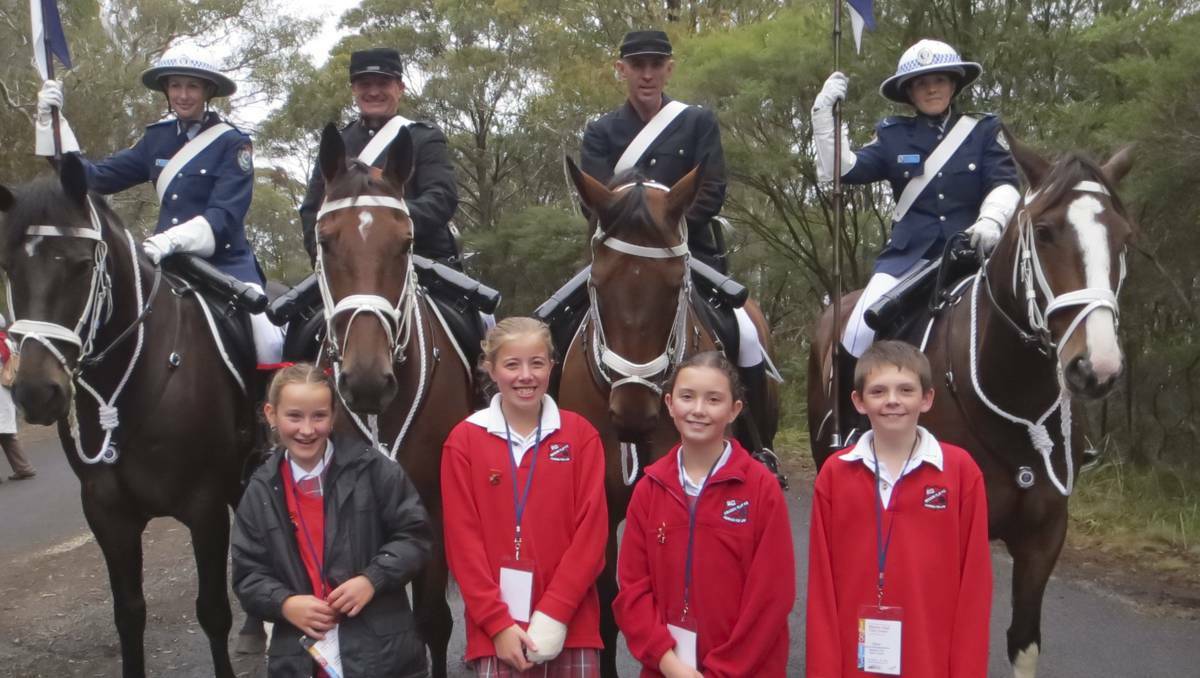 Four lucky students from Meadow Flat School were invited to take part in the invitation only bicentenary celebrations at Mt York. Pictured with the Mounted Police honour guard are Abbey Chadwick-Cocks, Faith Shean, Adrienne Slattery and Bryce Underhill.  