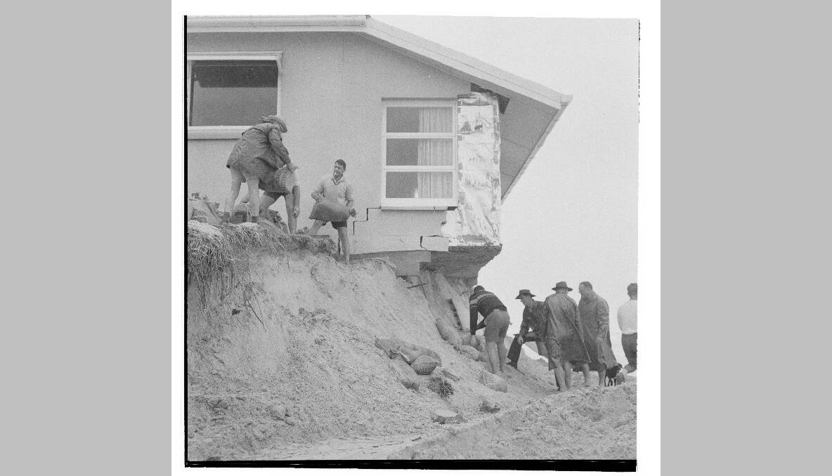 A house in Surfers Paradise hangs over an eroded cliff. Photo: National Archives of Australia