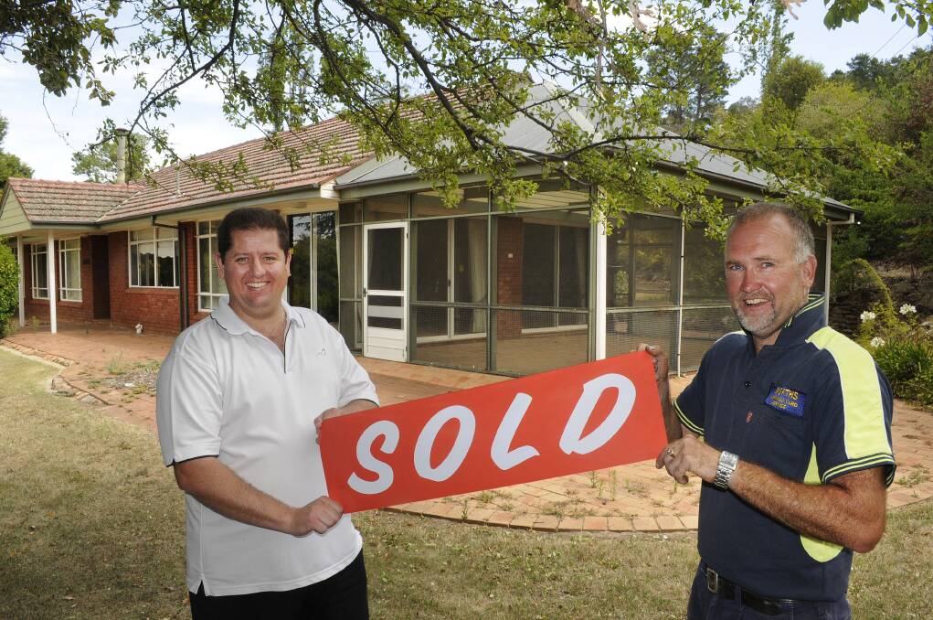 HANDOVER: Bathurst Regional Council property officer Ben Campbell and deputy mayor Ian North with the Conrod Straight property which has been sold. Photo: CHRIS SEABROOK 010814cbarlow