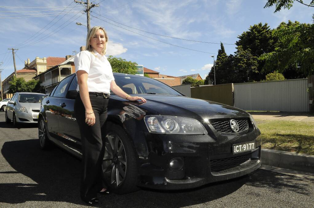WHAT A SHAME: Cassie Cogan with her SSV Holden. Her husband Sean, who has owned around 30 Holdens, was disappointed by the news that Holden will pull out of production in Australia. Photo: PHILL MURRAY 121113pcathy