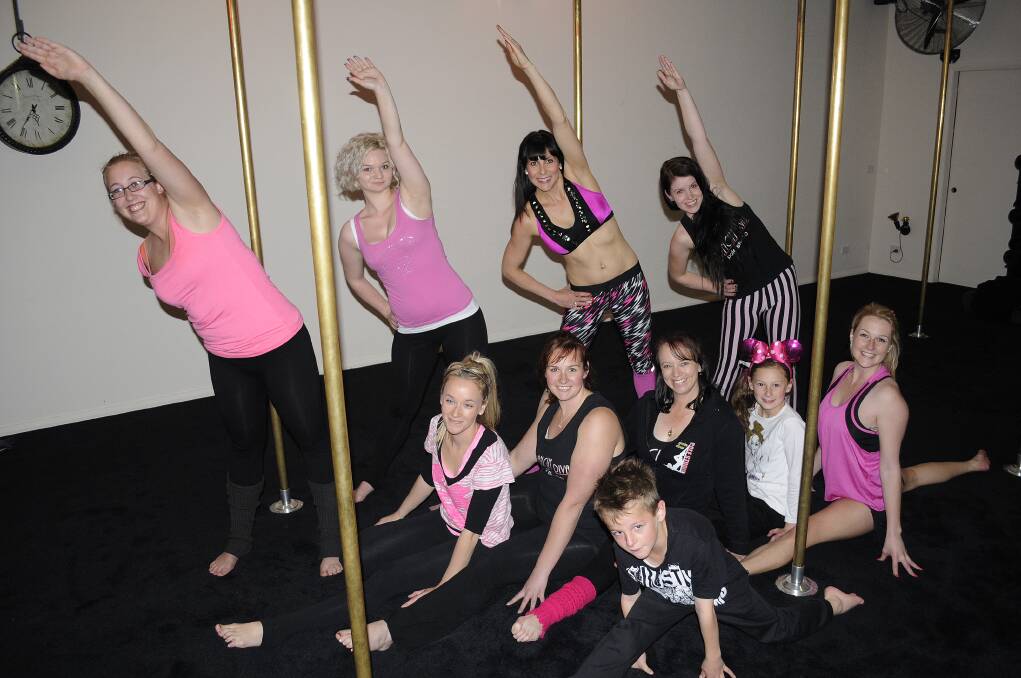 SUPER SUNDAY STRETCH: Dancin’ Divas Pole Studio dancers, at back, Imogen Storm, Danielle Cockerill, Ang Robertson and Chovelle Edmonds show off their moves alongside Shauna Falcke, Elyssa Denmead, Andrea Wills, Piper Robertson, Jess Spence and, at front, Jett Robertson. Photo: CHRIS SEABROOK 091613cpole