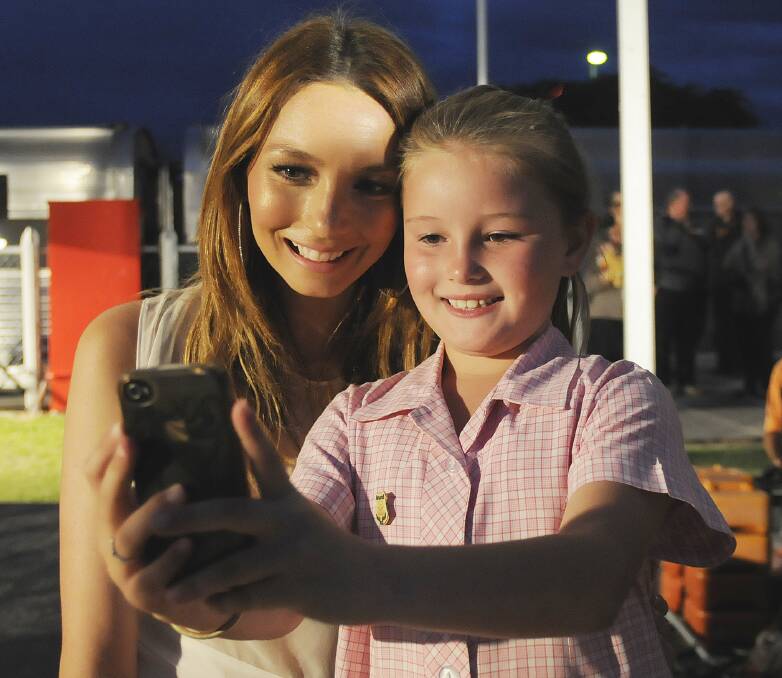 PICTURE PERFECT: Ricki-Lee Coulter poses with the Assumption School student Sophie Fitzgerald (nine) after the concert at Bathurst Railway Station. Photos: CHRIS SEABROOK 120413cricki15