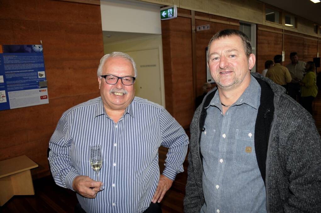TOASTING THE BEST: Mark Haley with Russell Cody from McWilliams Wines, Griffith caught up at the BRE&D launch event.