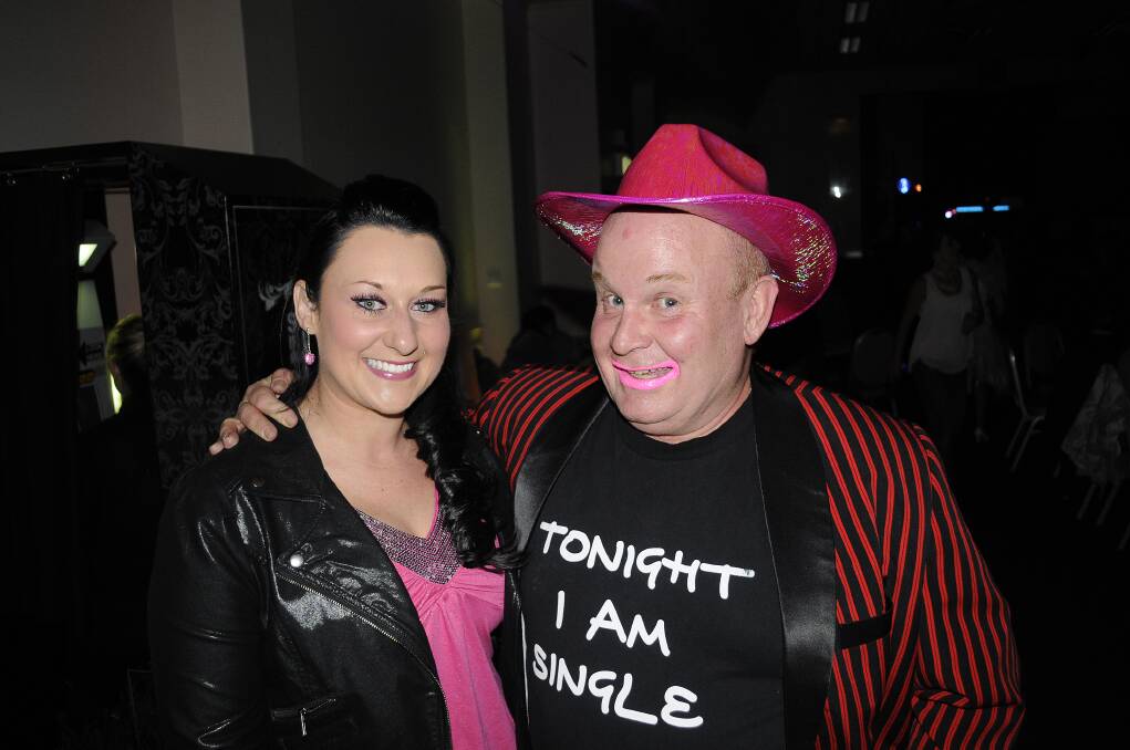PINKTEMBER: Kylie Roxburgh and Andy Wheeler ham it up for the camera at the Desperate and Dateless Disco. 