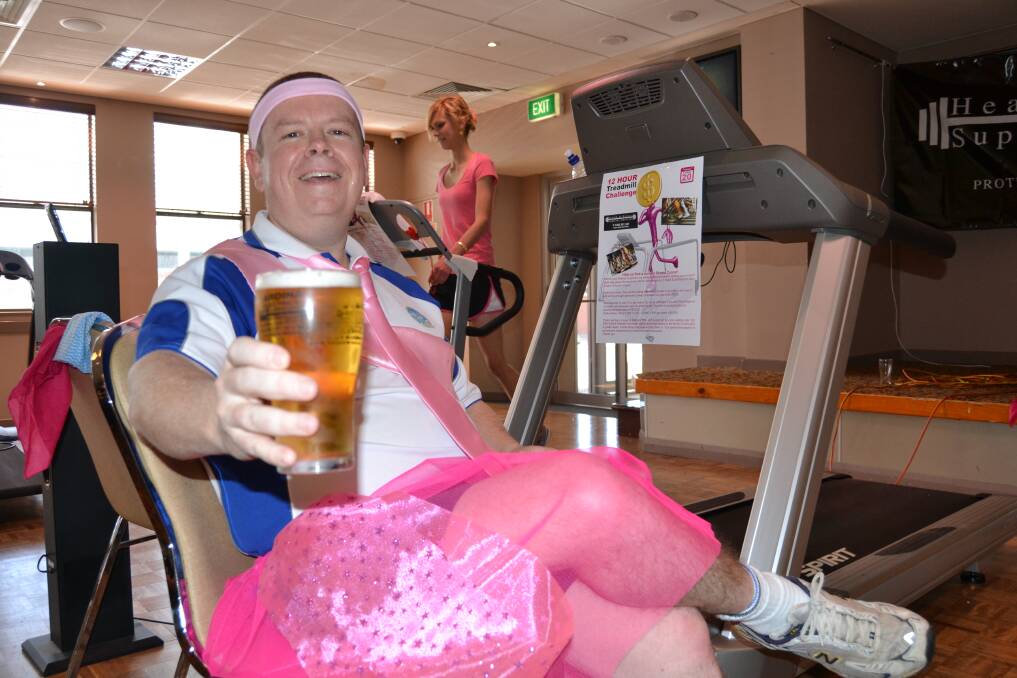REST UP: Bathurst RSL Club general manager Peter Sargent has a break, hamming it up for the camera during yesterday’s 12-Hour Treadmill Challenge, while Elisabeth Carter maintains the rage in the background. 