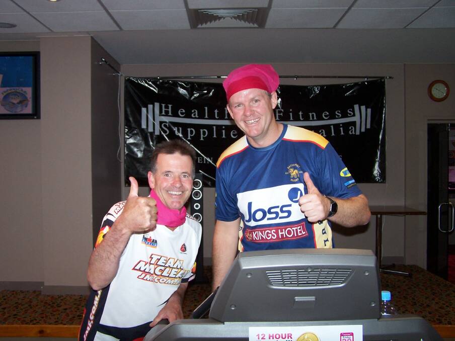 TREADMILL CHALLENGE: Western Advocate chief of staff Brian Wood, left, and RSL Club operations manager Mark Burns raising funds as part of the Pinktember promotion to raise money for research into breast cancer. 