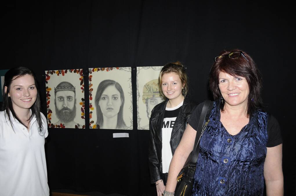 FACE VALUE: Darcy Watt shows off her talents to her sister Jamie and mum Toni at the Kelso High art and photography exhibition. 