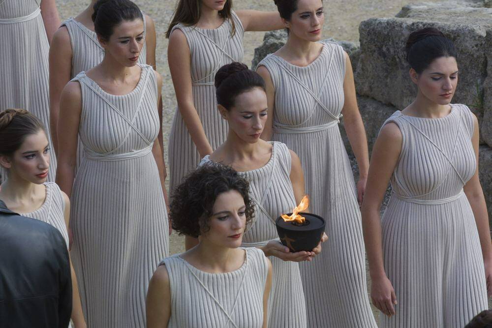 Priestesses carry the Olympic flame out of the Temple of Hera in Olympia, Greece in 2001. Photo: Getty Images