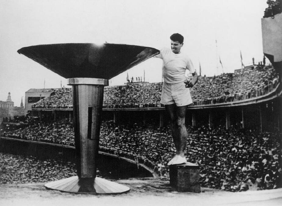 Ron Clarke of Australia lights the Olympic Torch at the opening ceremony of the 17th Olympic Games held in Melbourne during 1956. Photo: Getty Images