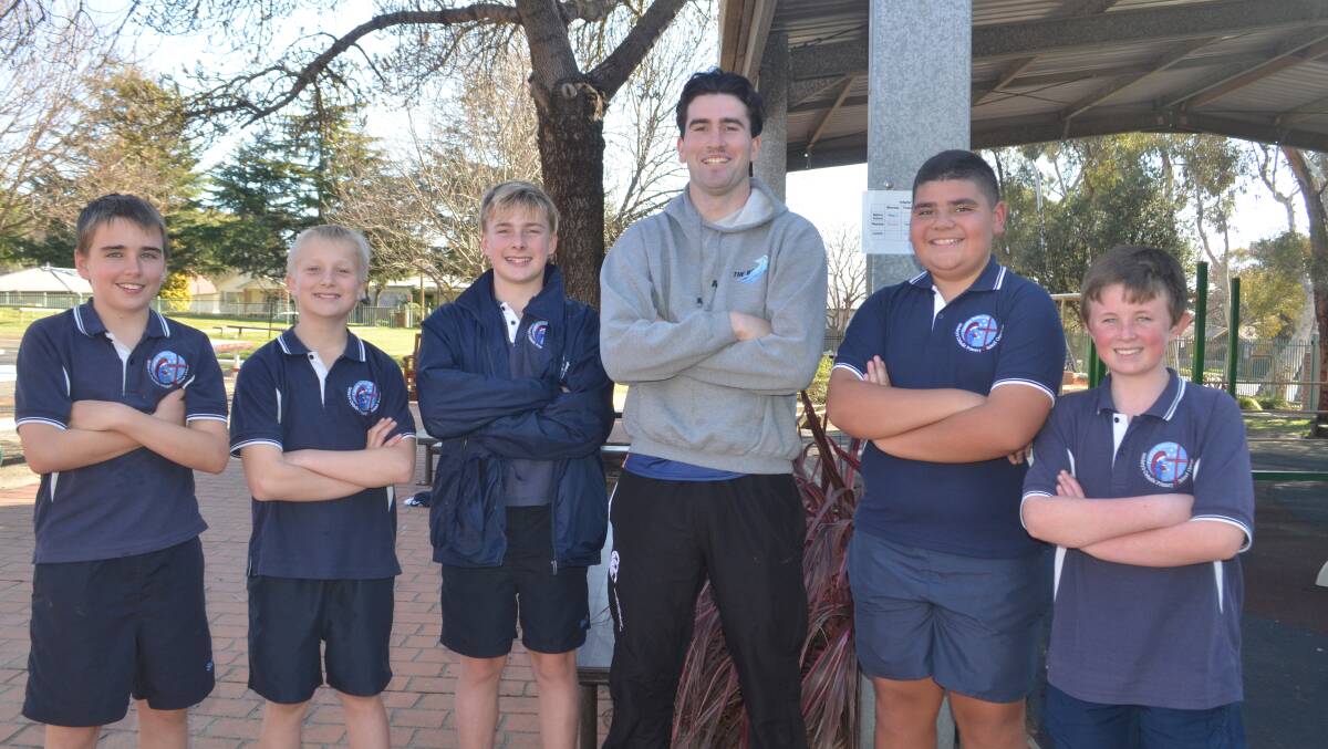 St Mary's students and Orange CYMS juniors Harrison Jones, Toby Chalker, Cruz Carter, Tye Opetaia and Knox Hiney pictured with their Year 6 teacher and Hawks player Joe Coady. Picture by Dominic Unwin