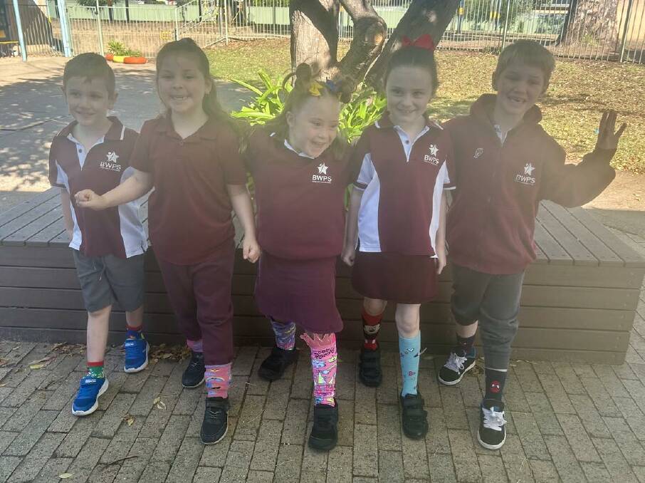 Zahli McDermott [middle] with some of her friends at Bathurst West Public School, all showing their support for World Down Syndrome Day by wearing bright, colourful socks on March 21. Picture by Amy Rees