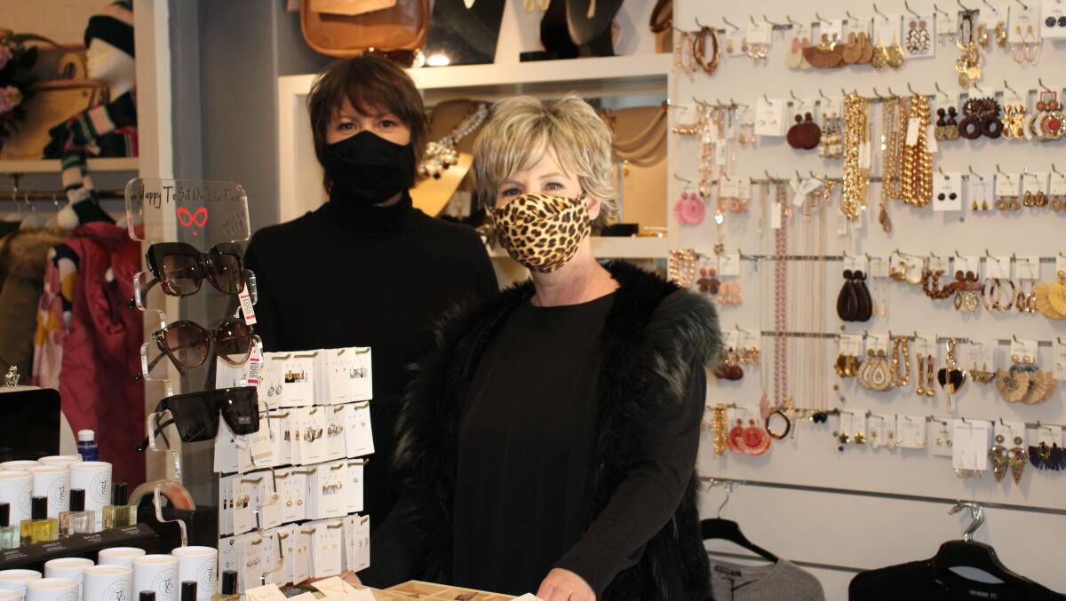KEEP SMILING: Judy Russell and Bron Aberley of Gorgeousness in their masks as per the restrictions. Photo: AMY REES