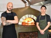 Church Bar chefs Marco Marano and Irwan Kok busy cooking pizzas following the reopening of the business. Picture: Amy Rees