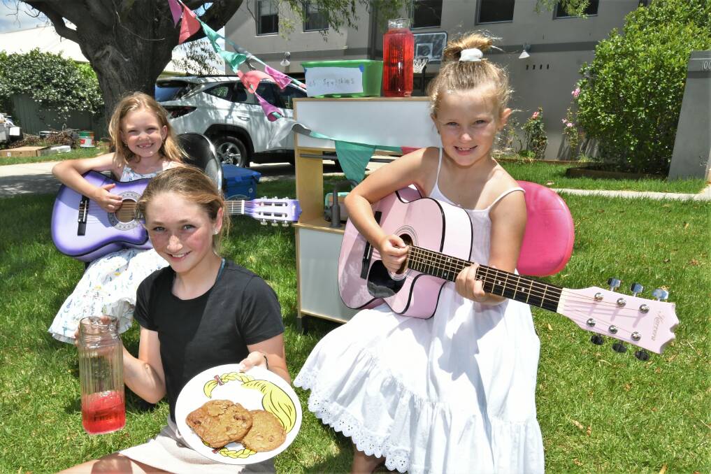 OPEN FOR BUSINESS: Ivy Powell, Mackenzie Smith and Harper Smith had a successful first day of business when running a stall outside of their house. Photo: CHRIS SEABROOK.