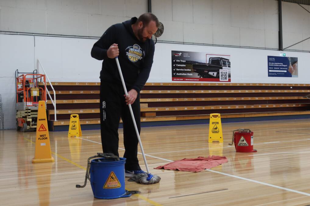 Bathurst Goldminers board member Iain Wood mopping up after yet another major leakage at the Bathurst Indoor Sports Stadium, following significant rainfall on April 5, 2024. Picture by Amy Rees