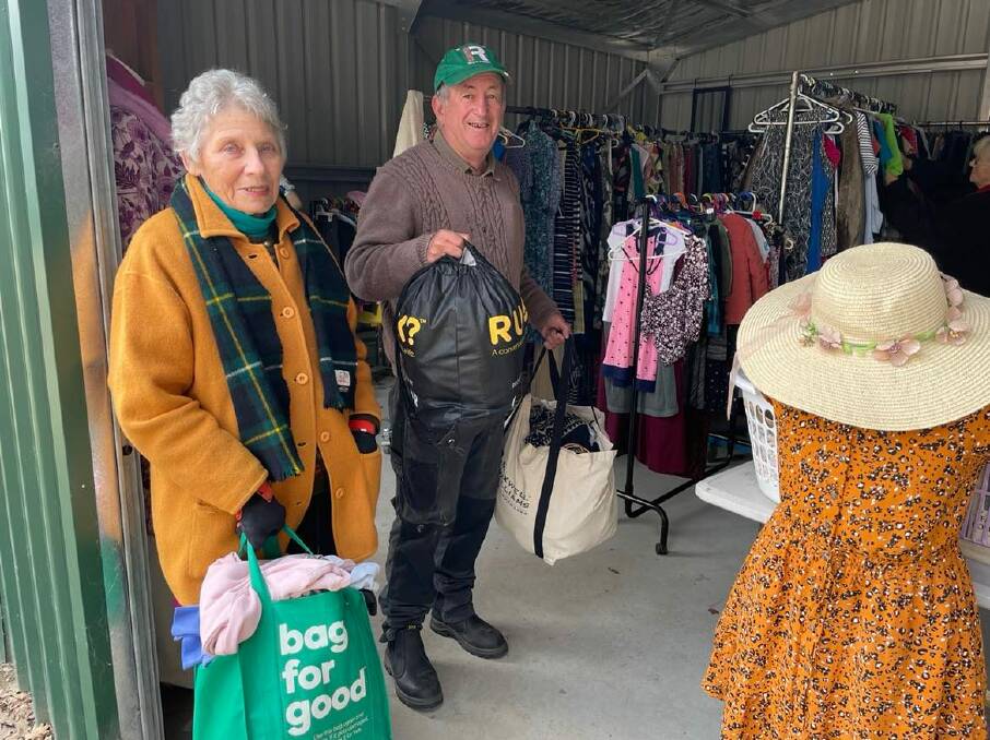 DONATIONS: Long-serving volunteer Shirley Burrow with Bobby Bourke and some of the donated clothes received. Photo: AMY REES.