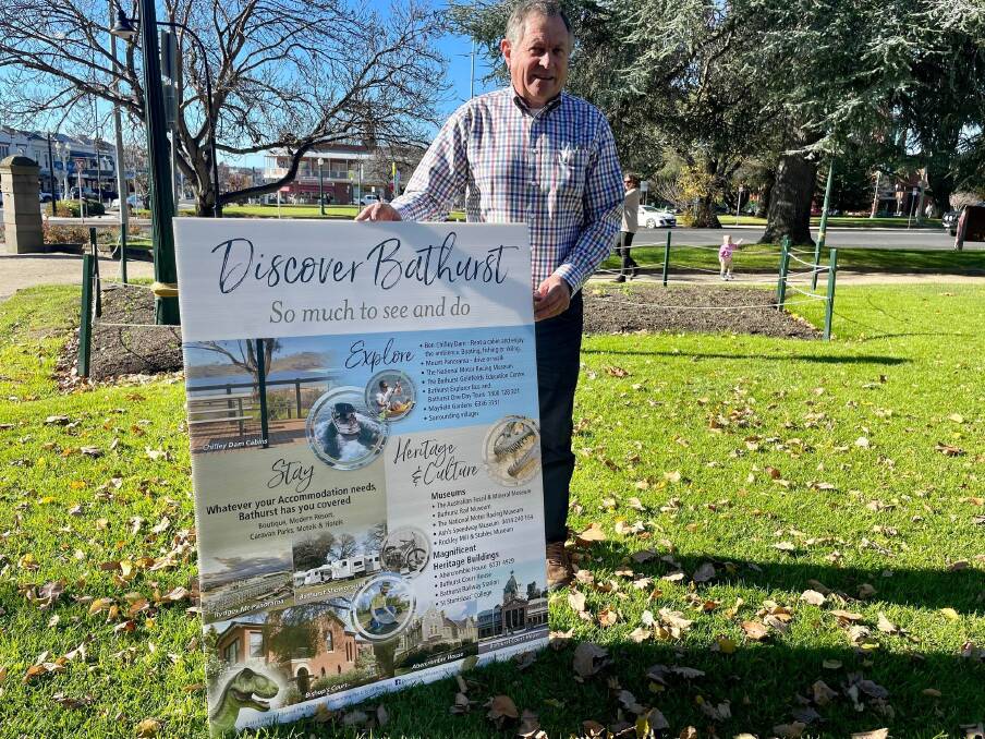 Peter Rogers with a sign he got printed himself, calling for better promotion of Bathurst. Picture: Amy Rees