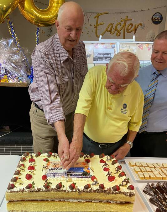 Life members Brian Tobin and John Faulkner with CEO life member Peter Sargent cutting the cake. Picture supplied
