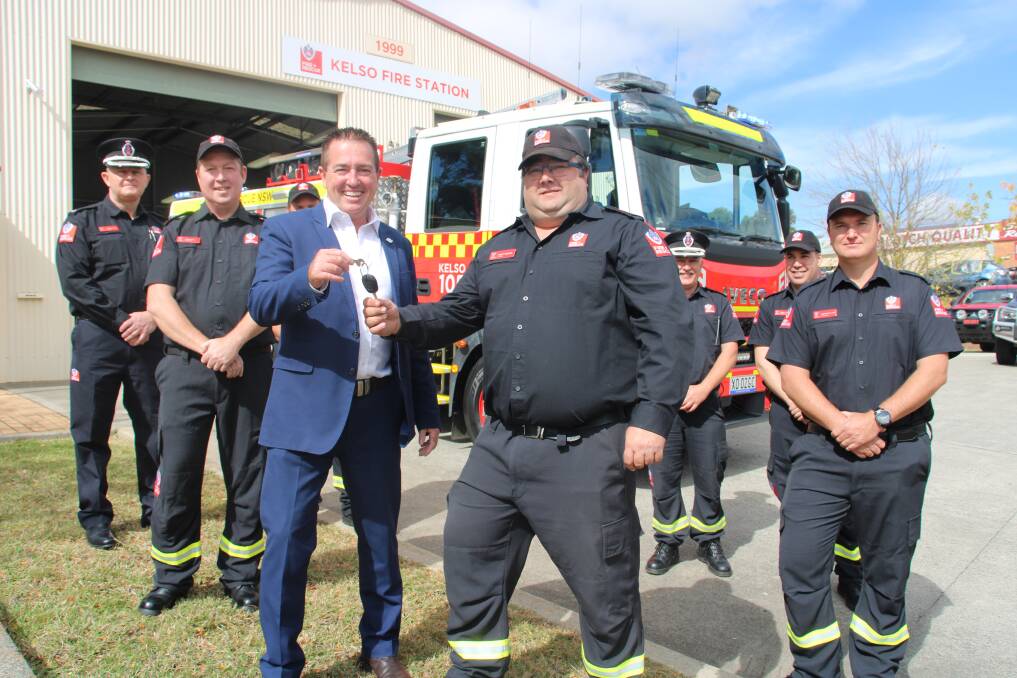 NEW WHEELS: Bathurst MP Paul Toole with 105 Kelso captain Scott Wilson and the fire crew in front of their new fire truck. Photo: AMY REES.