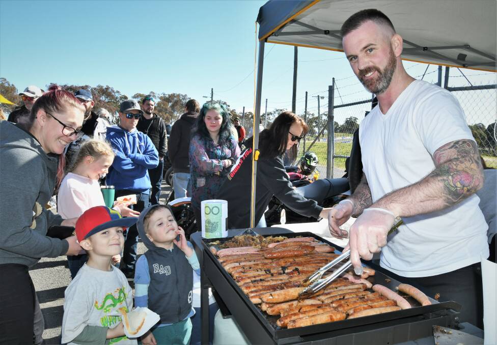 Nick Galvin serving up free sausages at the Men's Mental Health Awareness barbecue on Sunday. Picture: Chris Seabrook