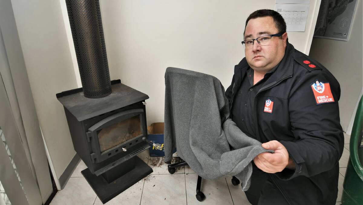 STAY SAFE: Kelso Fire Brigade Captain Scott Wilson discussing the dangers of drying clothes in front of a fire or heater. Photo: CHRIS SEABROOK.