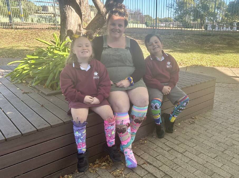 Zahli and Kye McDermott with their mum Danielle Armstrong sporting their colourful socks for World Down Syndrome Day on March 21. Picture by Amy Rees 