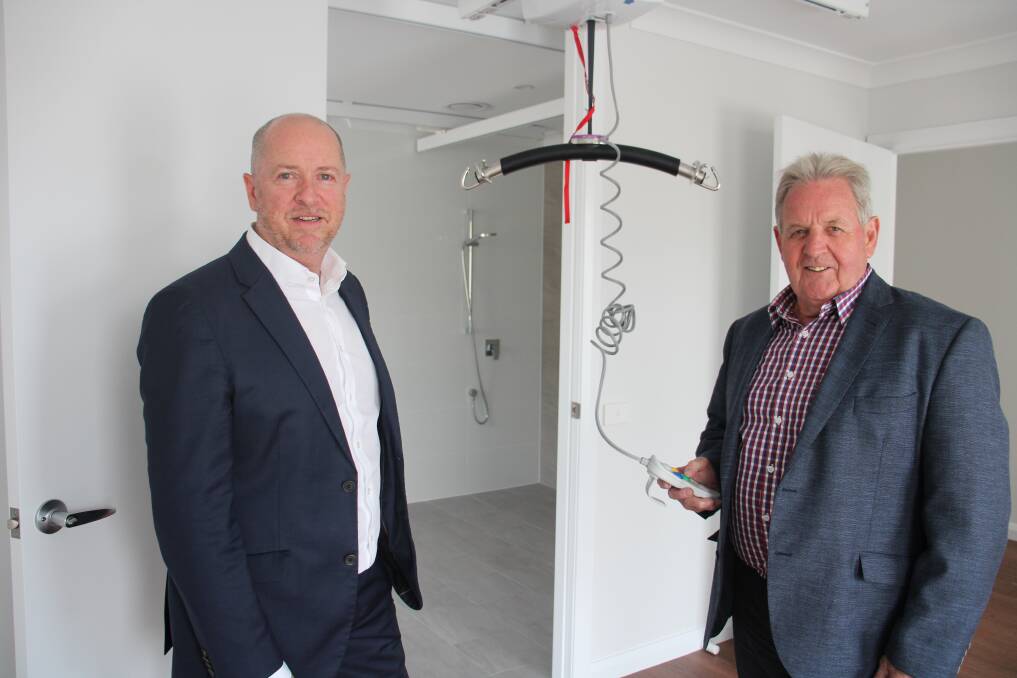 SUPPORT: Vivability CEO Nick Packham and mayor Robert Taylor testing the H frame ceiling hoist at the newly completed high physical support needs house. Photo: AMY REES.