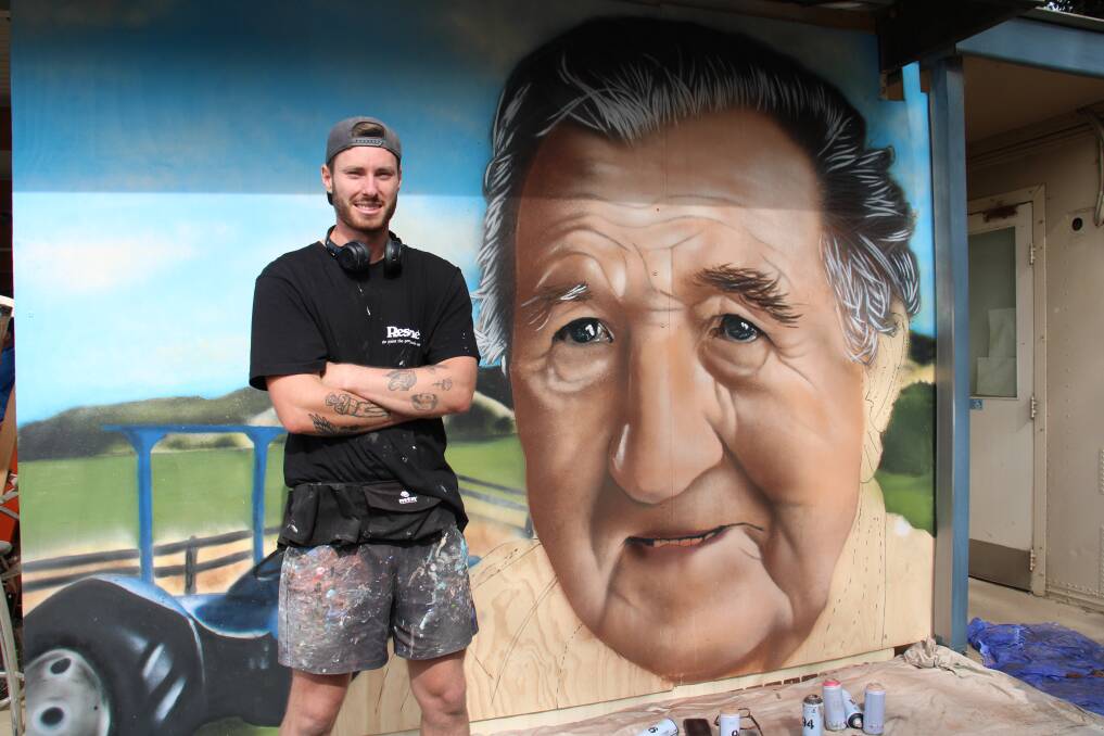 ARTWORK: Callum Hotham putting the finishing touches on a mural of his grandfather at Hotham's Bathurst. Photo: AMY REES.