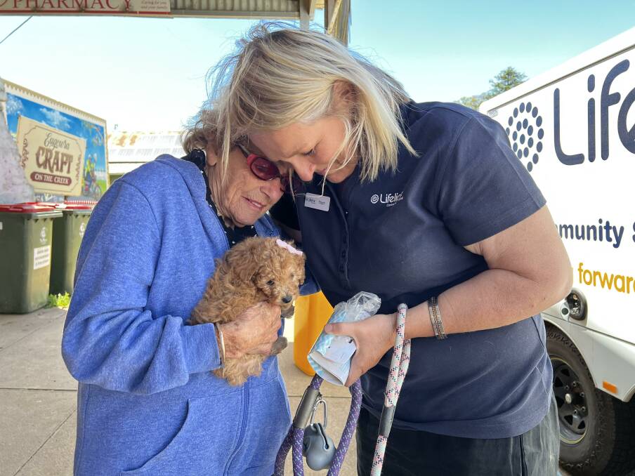 Stephanie Robinson gifting Jeanette Norris with a cavoodle puppy 'Miss Truffle'. Picture supplied