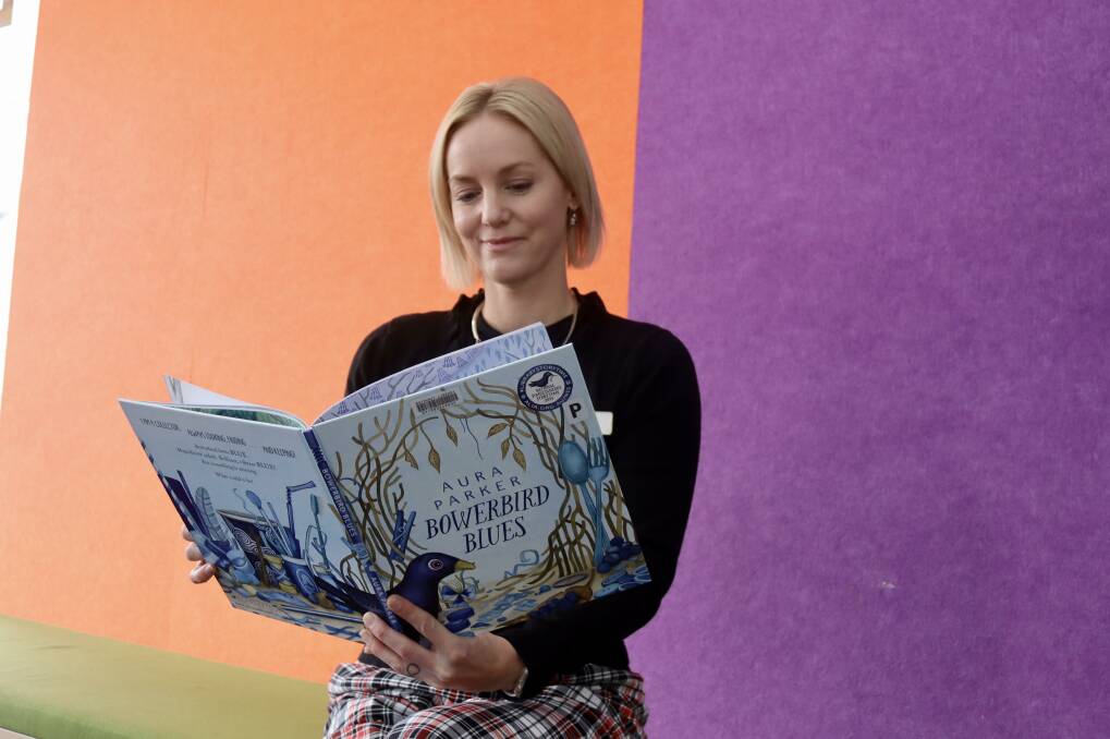 Bathurst Library programs officer Natalie Conn taking a look at the 2024 National Simultaneous Storytime book, Bowerbird Blues. Picture by Amy Rees
