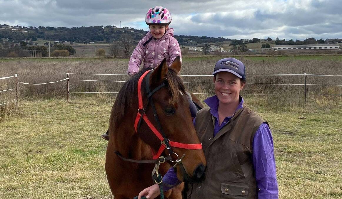 NEW LIFE: Cynthia Bourke with retired standardbred SJ and little Savannah taking the reins. Photo: SUPPLIED.