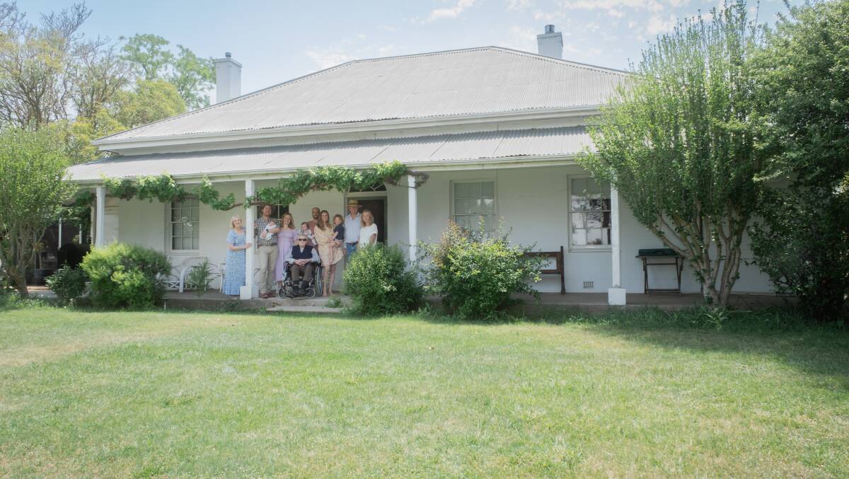The Jones family standing in front of their house, and the original homestead at The Grange, in November 2023, around 200 years after it was built. Picture by James Arrow
