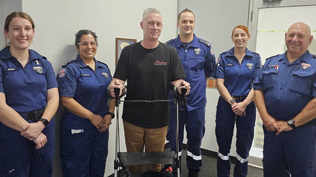 Mark Bonfield with paramedic Ron Gavin (far right) and the team of paramedics that saved Mr Bonfield's life. Picture by Reidun Berntsen. 