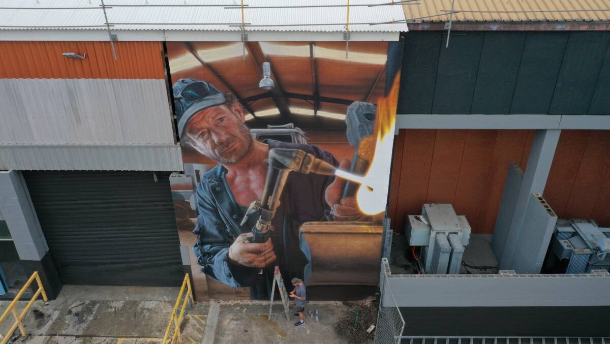 Callum Hotham painting a large mural for Manufactor.Penrith, an industrial manufacturing precinct.. Picture supplied