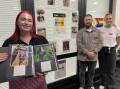 Social Futures staff Caitlin Bennett, Drew Churches and Sam Thompson with some of the pictures that will be on display as part of Photovoice. Picture by Alise McIntosh
